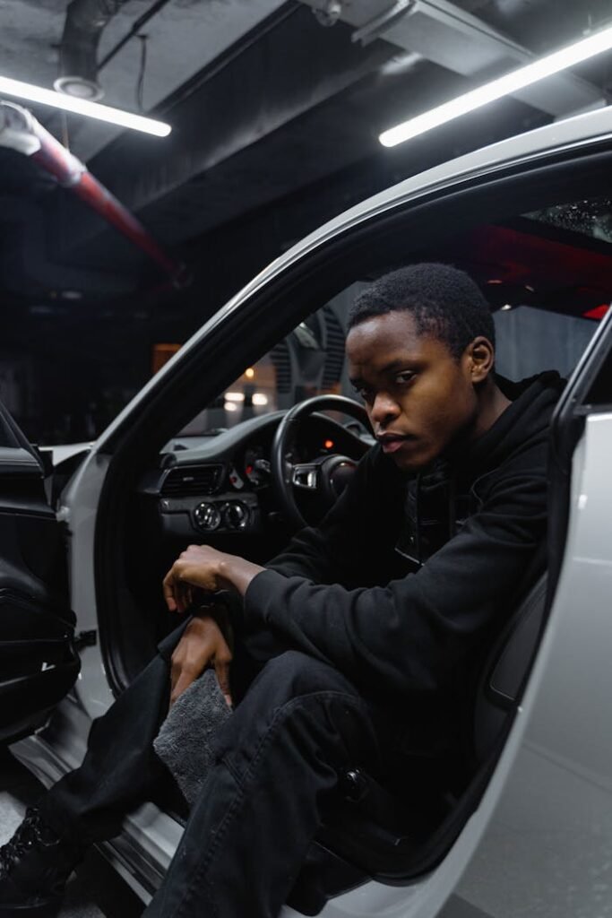 Man in Black Leather Jacket Driving Car